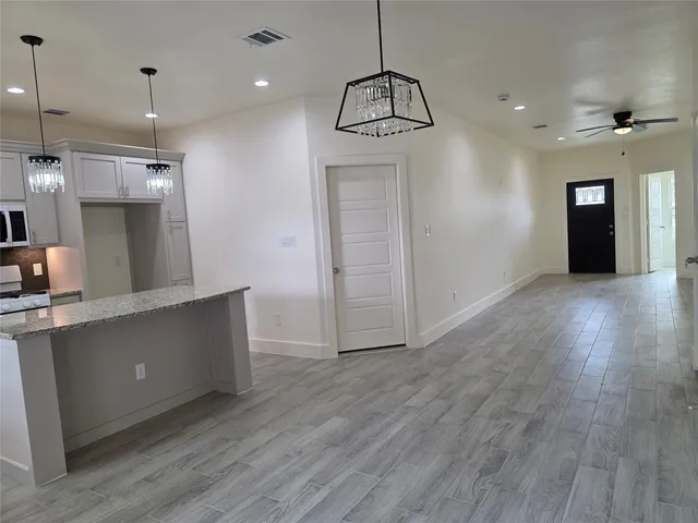 a view of a kitchen with a dishwasher and a refrigerator