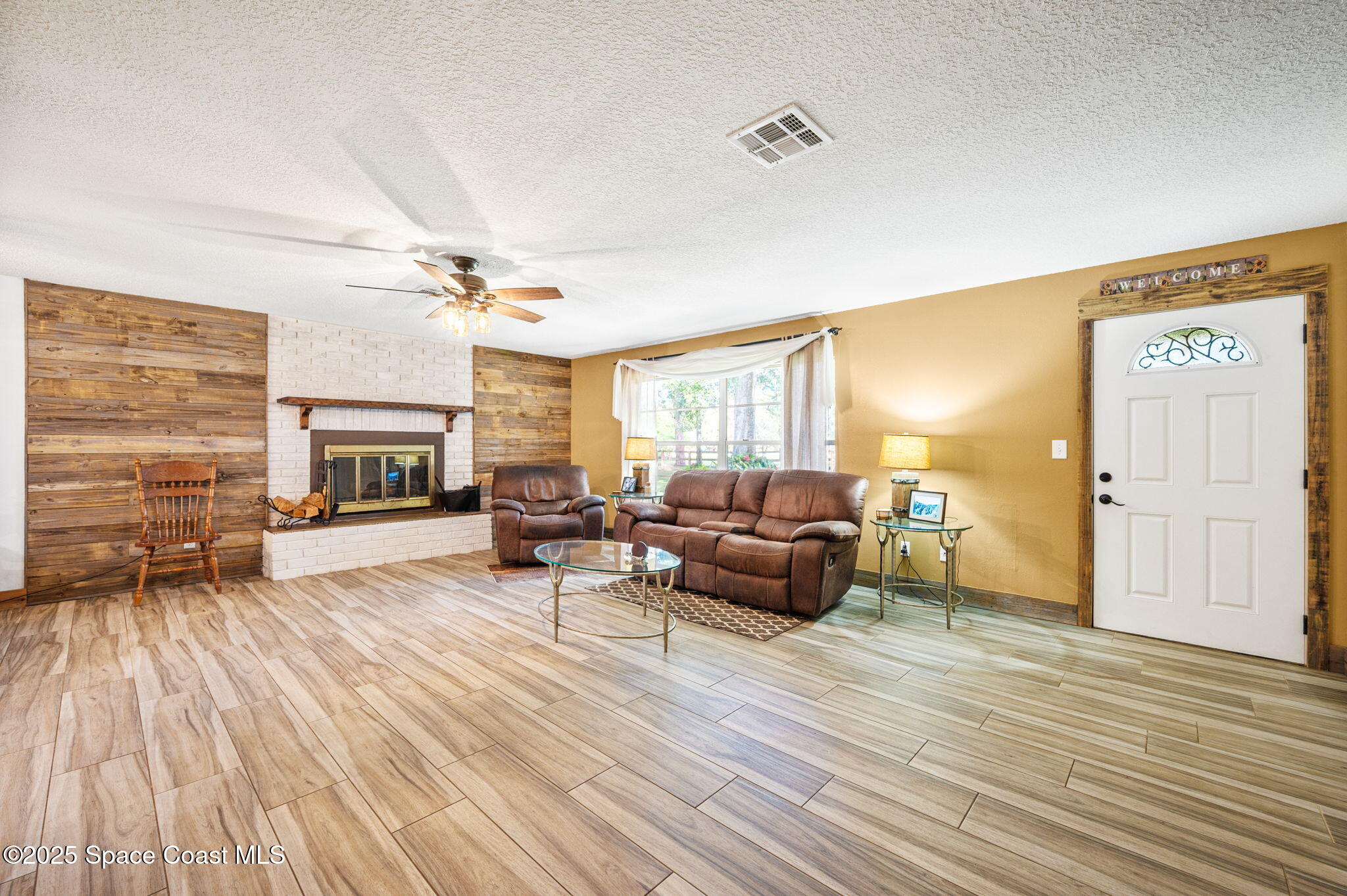 4505 Eldorado Way Melbourne, FL 32934 - Photo 16 of 78 a living room with furniture and a fireplace