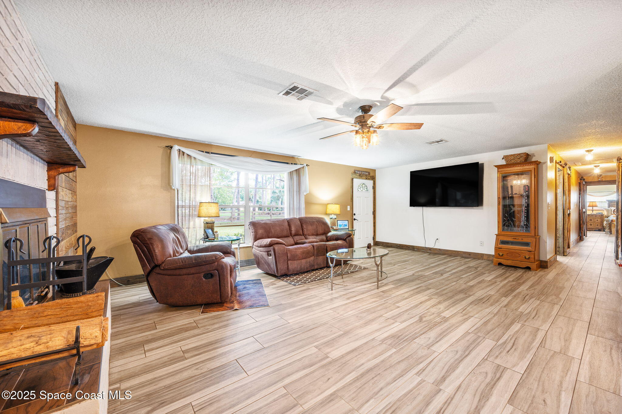 4505 Eldorado Way Melbourne, FL 32934 - Photo 17 of 78 a living room with furniture and a flat screen tv