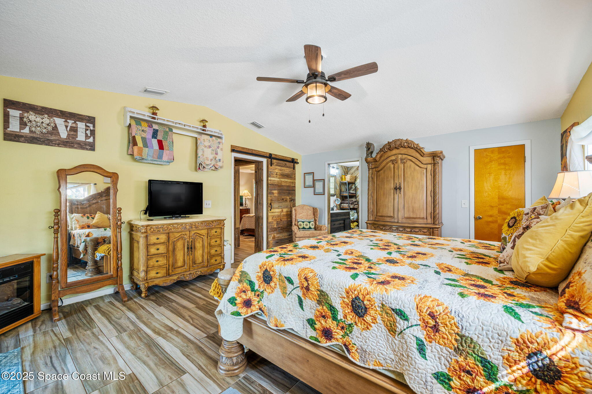 4505 Eldorado Way Melbourne, FL 32934 - Photo 29 of 78 a bedroom with a bed and a flat screen tv