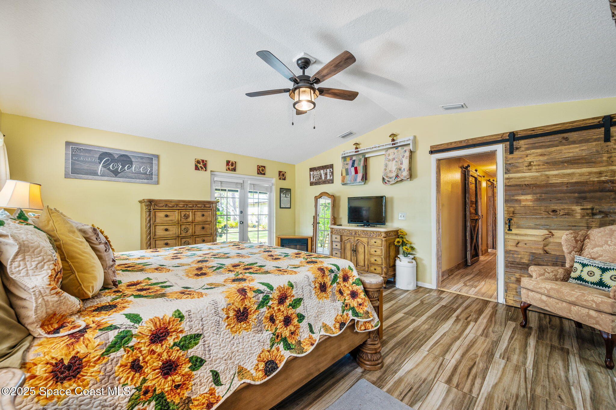 4505 Eldorado Way Melbourne, FL 32934 - Photo 31 of 78 a bedroom with a bed and wooden floor
