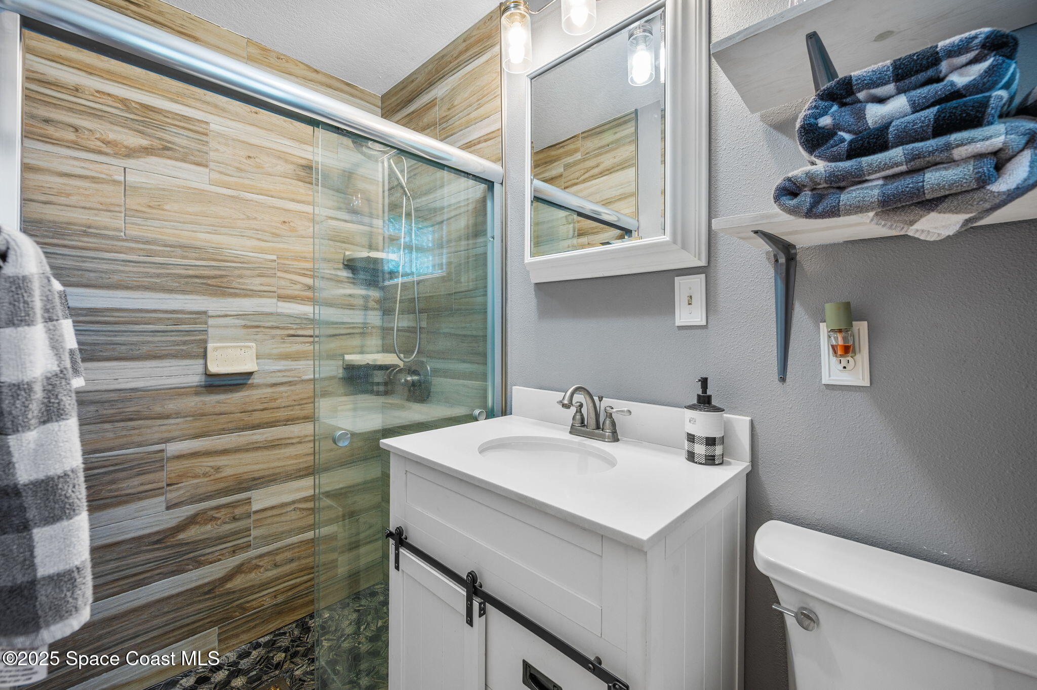 4505 Eldorado Way Melbourne, FL 32934 - Photo 35 of 78 a bathroom with a sink and a mirror