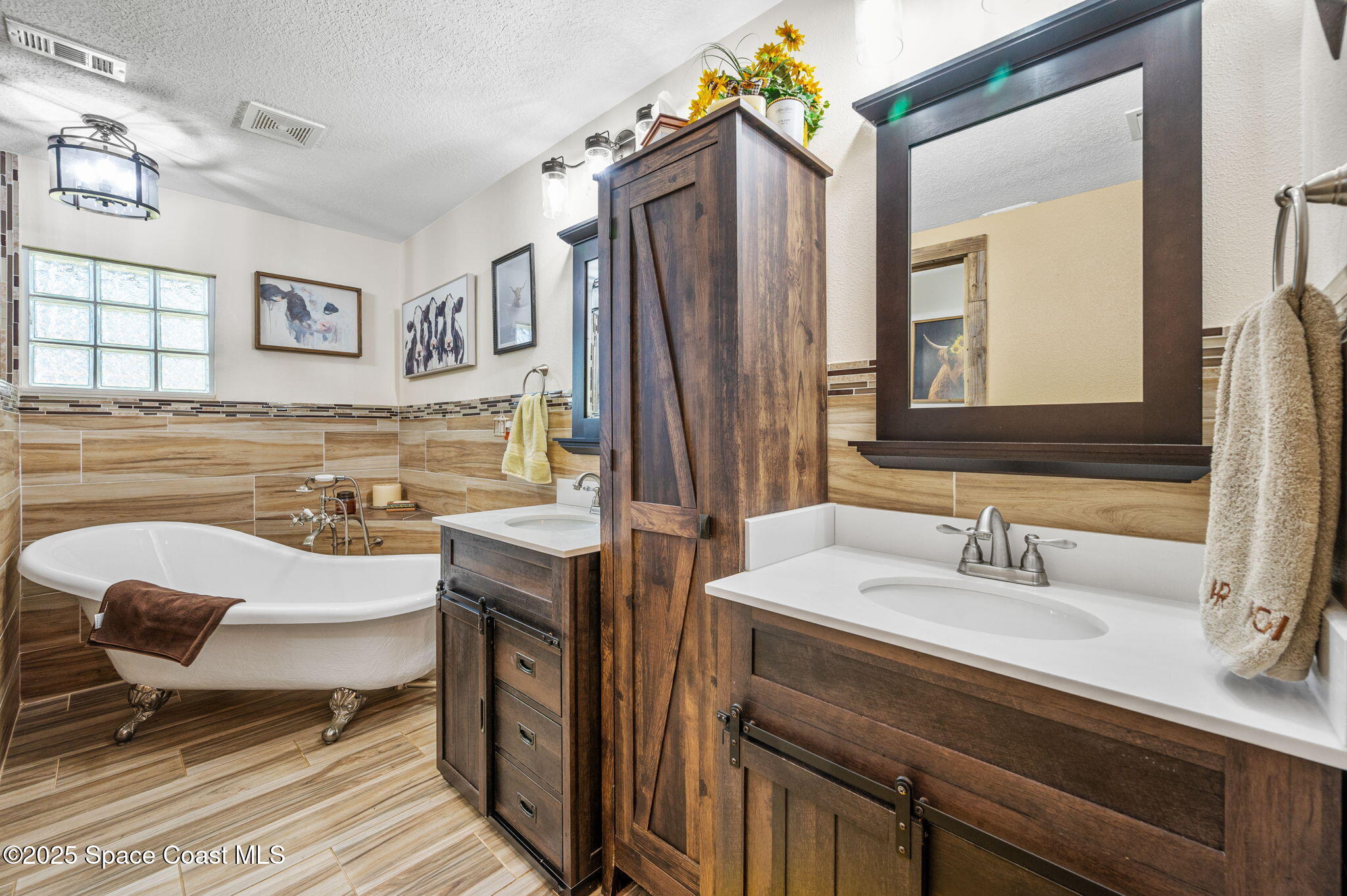 4505 Eldorado Way Melbourne, FL 32934 - Photo 38 of 78 a spacious bathroom with a sink double vanity and a mirror