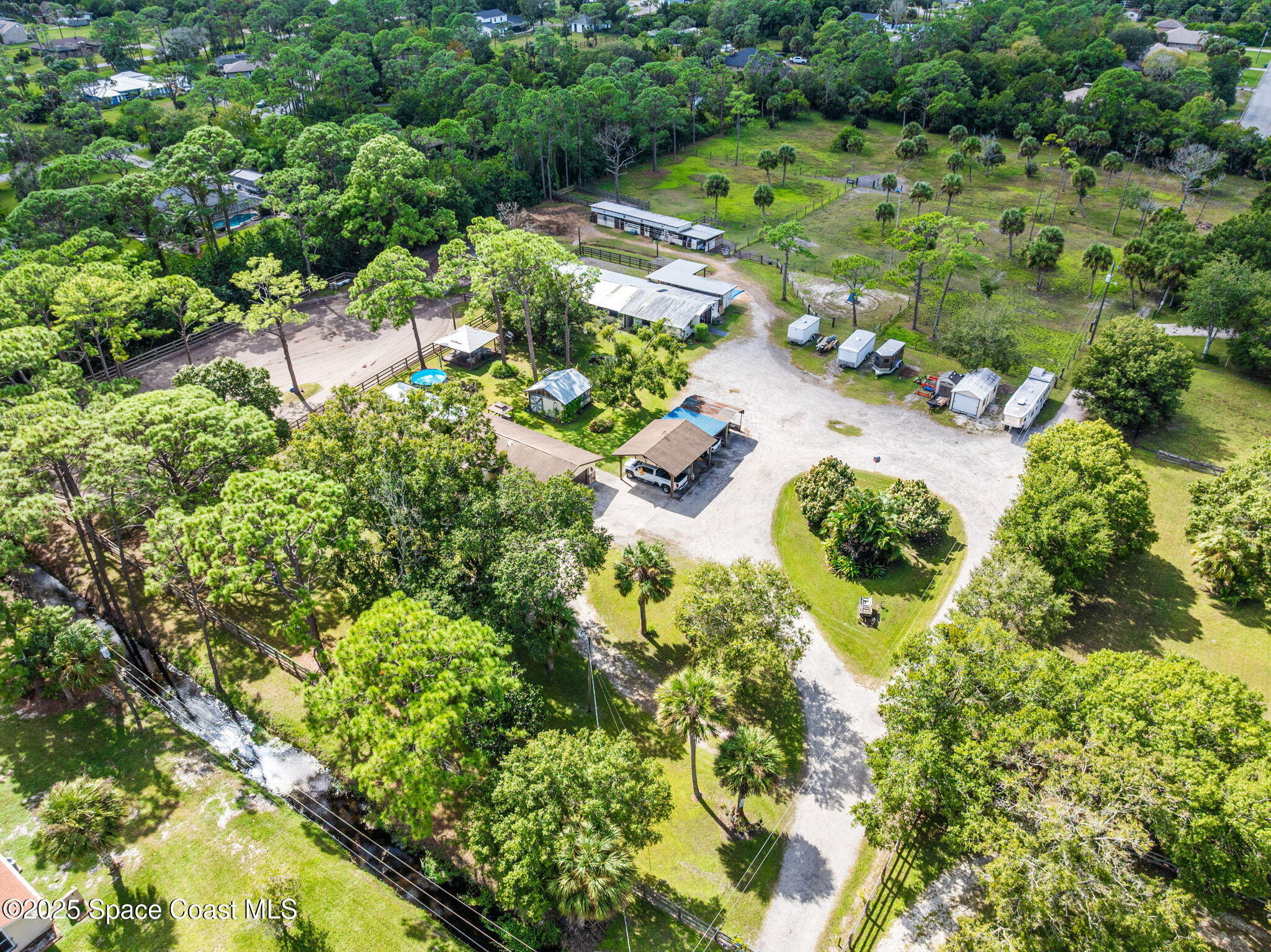 4505 Eldorado Way Melbourne, FL 32934 - Photo 46 of 78 an aerial view of residential house with outdoor space and trees all around