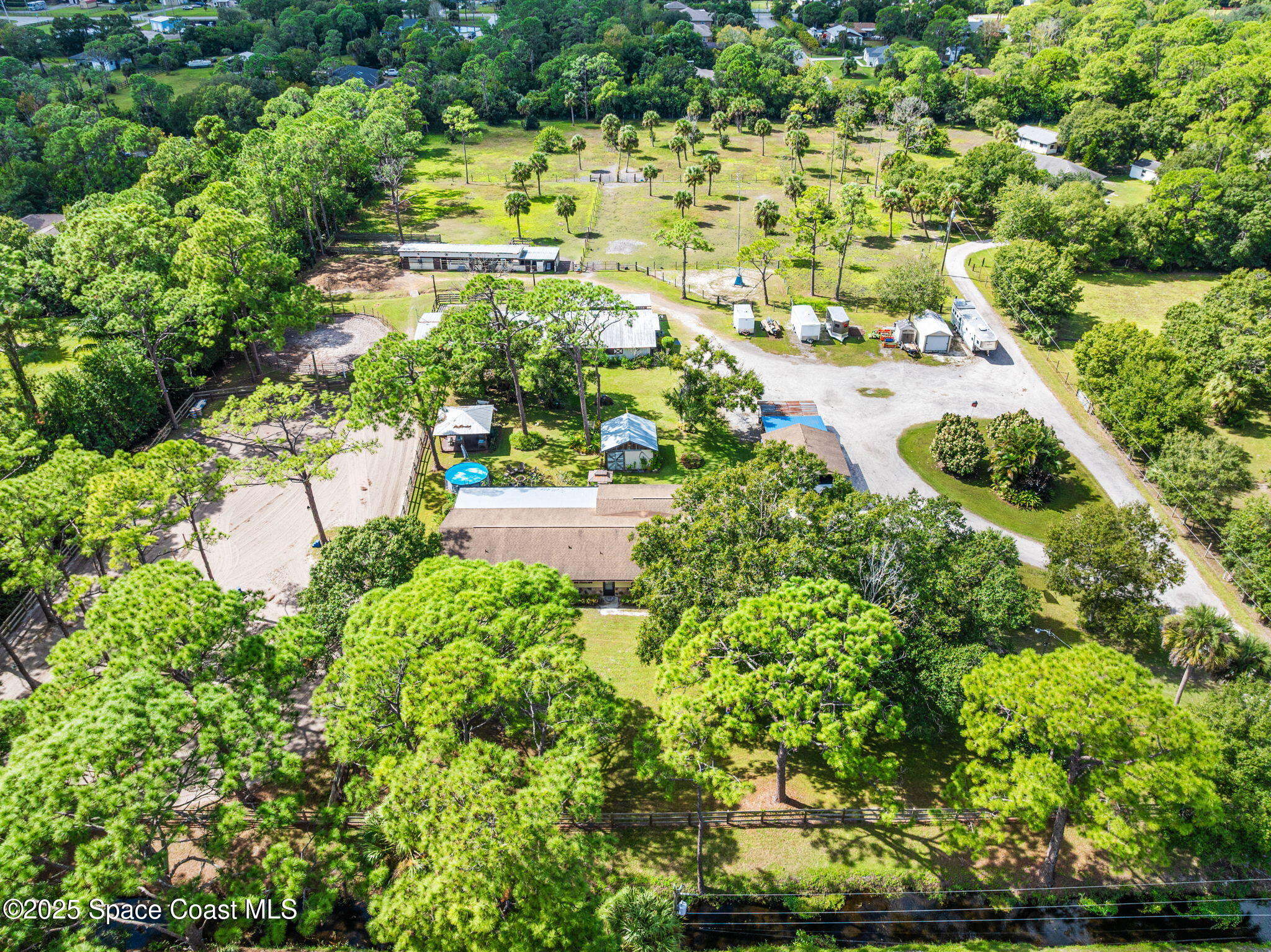 4505 Eldorado Way Melbourne, FL 32934 - Photo 50 of 78 an aerial view of residential houses with outdoor space and trees all around