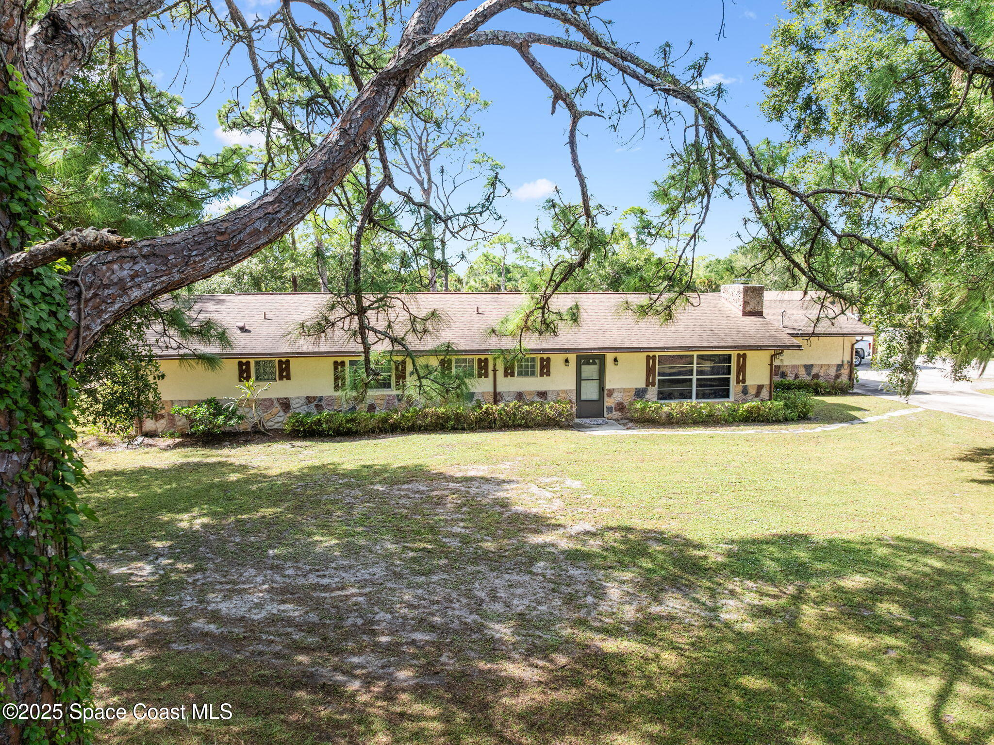 4505 Eldorado Way Melbourne, FL 32934 - Photo 77 of 78 a front view of a house with a big yard