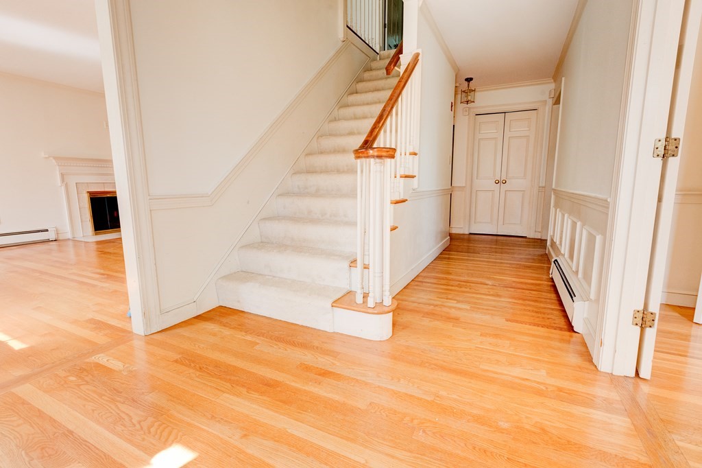 44 Colgate Road Needham, MA 02492 - Photo 4 of 30 a view of a hallway with wooden floor and staircase