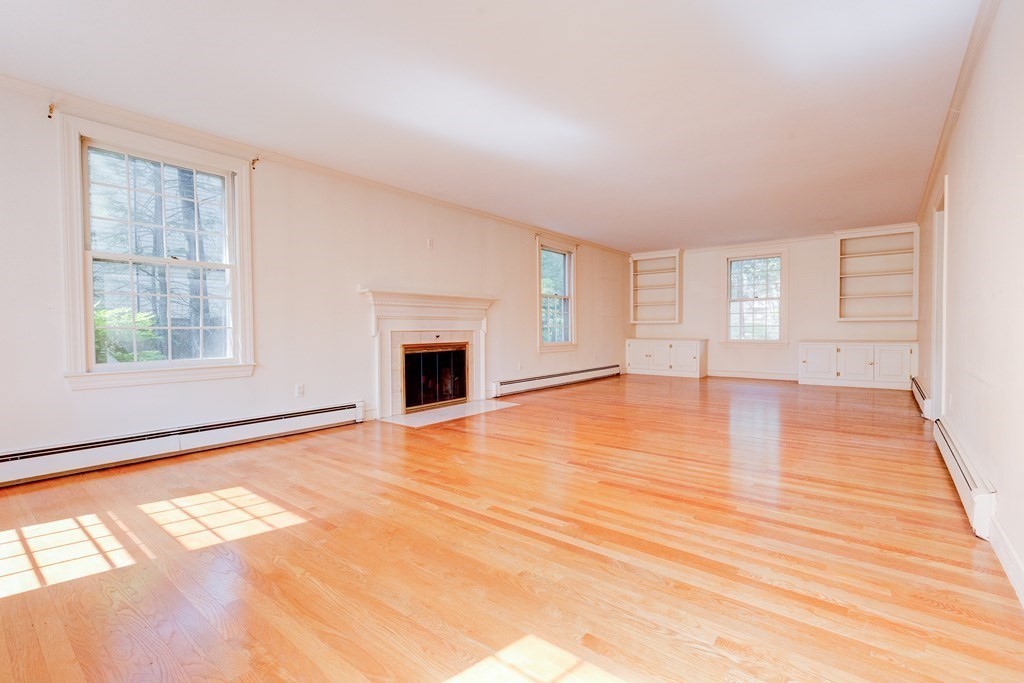 44 Colgate Road Needham, MA 02492 - Photo 5 of 30 a view of empty room with wooden floor and fireplace