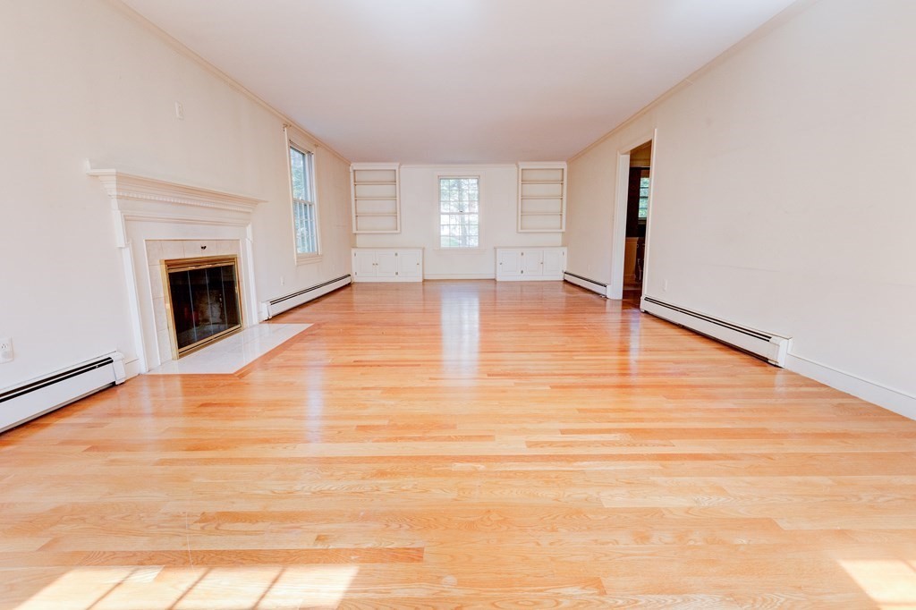 44 Colgate Road Needham, MA 02492 - Photo 6 of 30 a view of empty room with wooden floor and fireplace