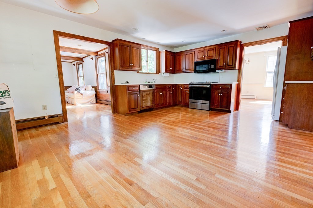 44 Colgate Road Needham, MA 02492 - Photo 10 of 30 a large kitchen with a sink stainless steel appliances and cabinets