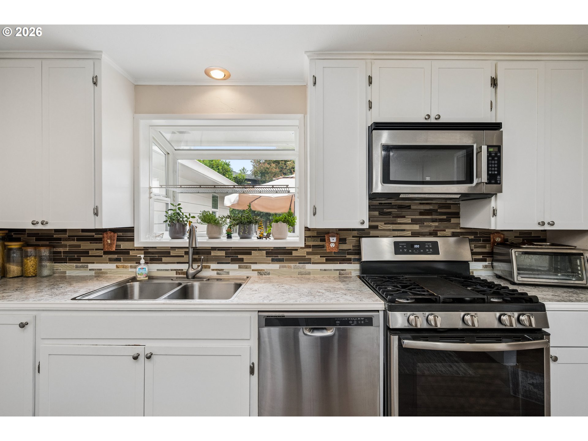 420 Riverview Boulevard Springfield, OR 97477 - Photo 10 of 28 a kitchen with a sink stove and microwave