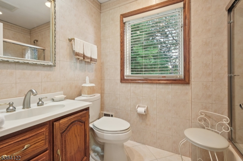 20 Kew Drive Springfield, NJ 07081 - Photo 12 of 19 a bathroom with a sink a toilet and a mirror