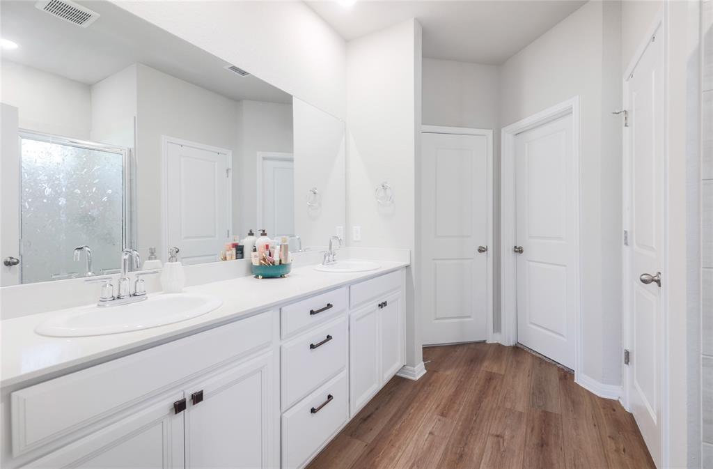 2815 Haystack Lane Round Rock, TX 78665 - Photo 14 of 30 Full bath featuring double vanity, a shower stall, and dark wood-style floors