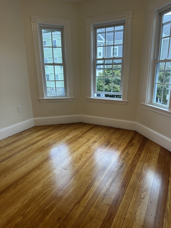 10 Dalrymple Street, Unit 2 Boston, MA 02130 - Photo 12 of 13 a view of an empty room with wooden floor and a window