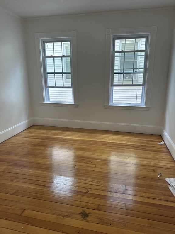10 Dalrymple Street, Unit 2 Boston, MA 02130 - Photo 4 of 13 wooden floor in an empty room with a window