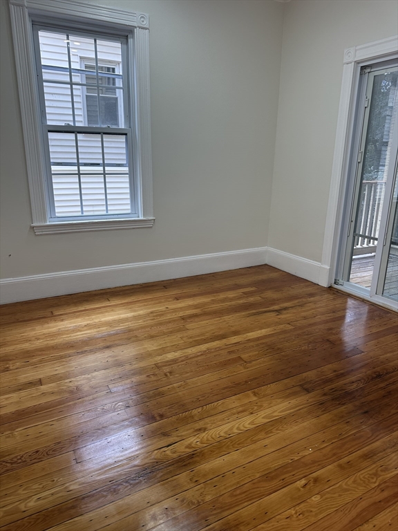 10 Dalrymple Street, Unit 2 Boston, MA 02130 - Photo 8 of 13 an empty room with wooden floor and windows