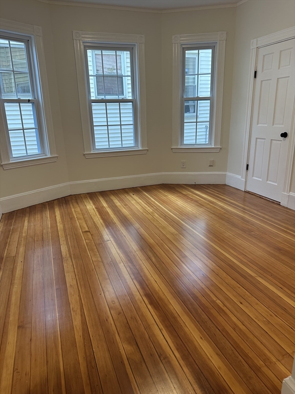 10 Dalrymple Street, Unit 2 Boston, MA 02130 - Photo 9 of 13 an empty room with wooden floor and windows