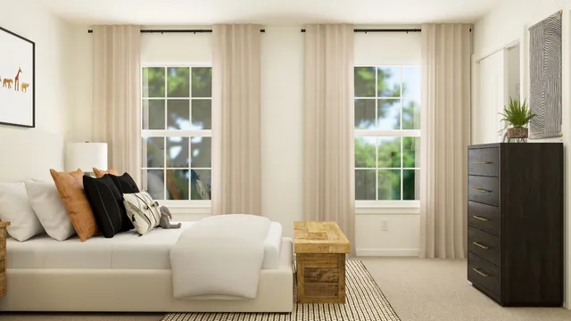 a bed sitting in a bedroom next to a bathroom