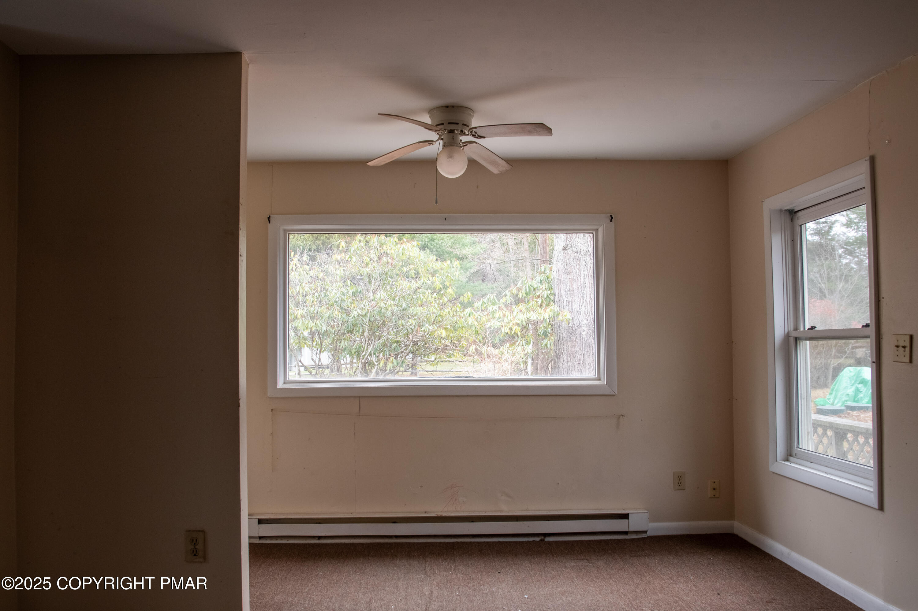 111 Rippling Brook Road Canadensis, PA 18325 - Photo 13 of 50 an empty room with windows and ceiling fan