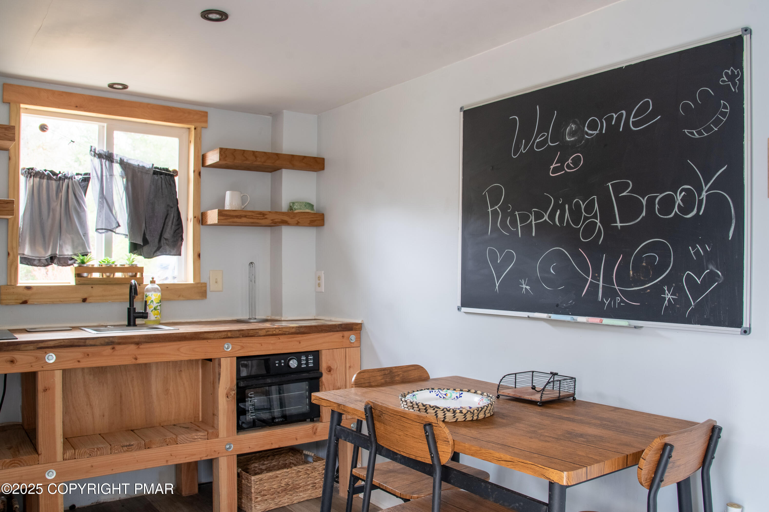 111 Rippling Brook Road Canadensis, PA 18325 - Photo 23 of 50 a kitchen with a table and chairs in it