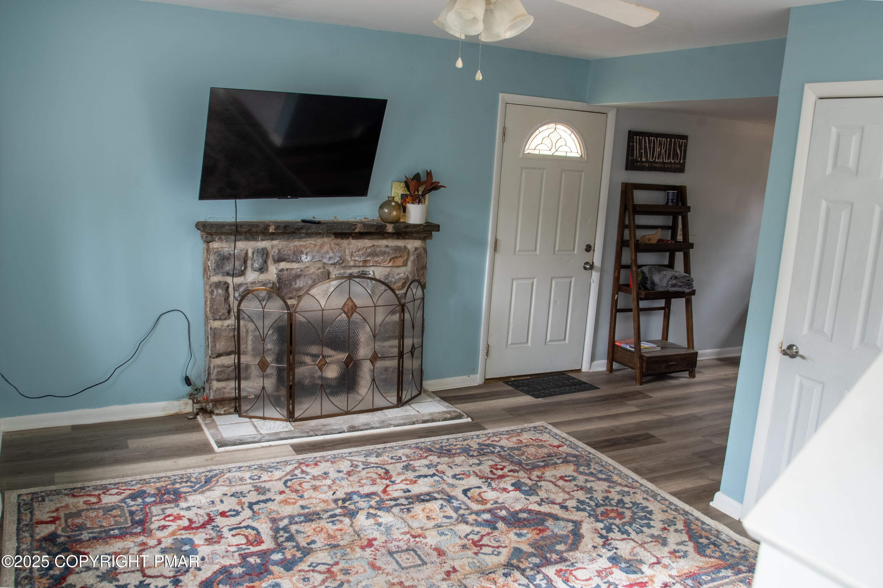 111 Rippling Brook Road Canadensis, PA 18325 - Photo 26 of 50 a living room with a fireplace and a flat screen tv