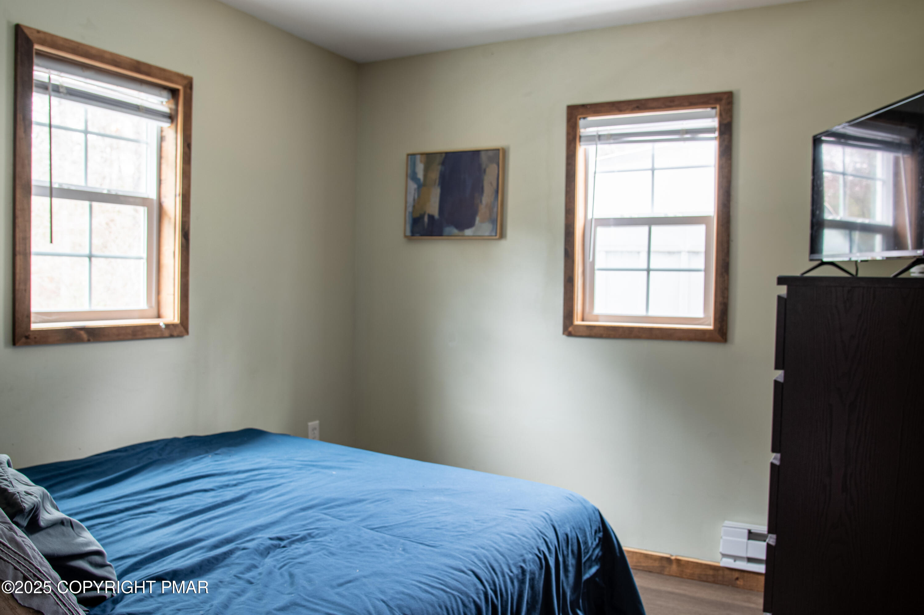 111 Rippling Brook Road Canadensis, PA 18325 - Photo 44 of 50 a bedroom with a bed and wooden floor