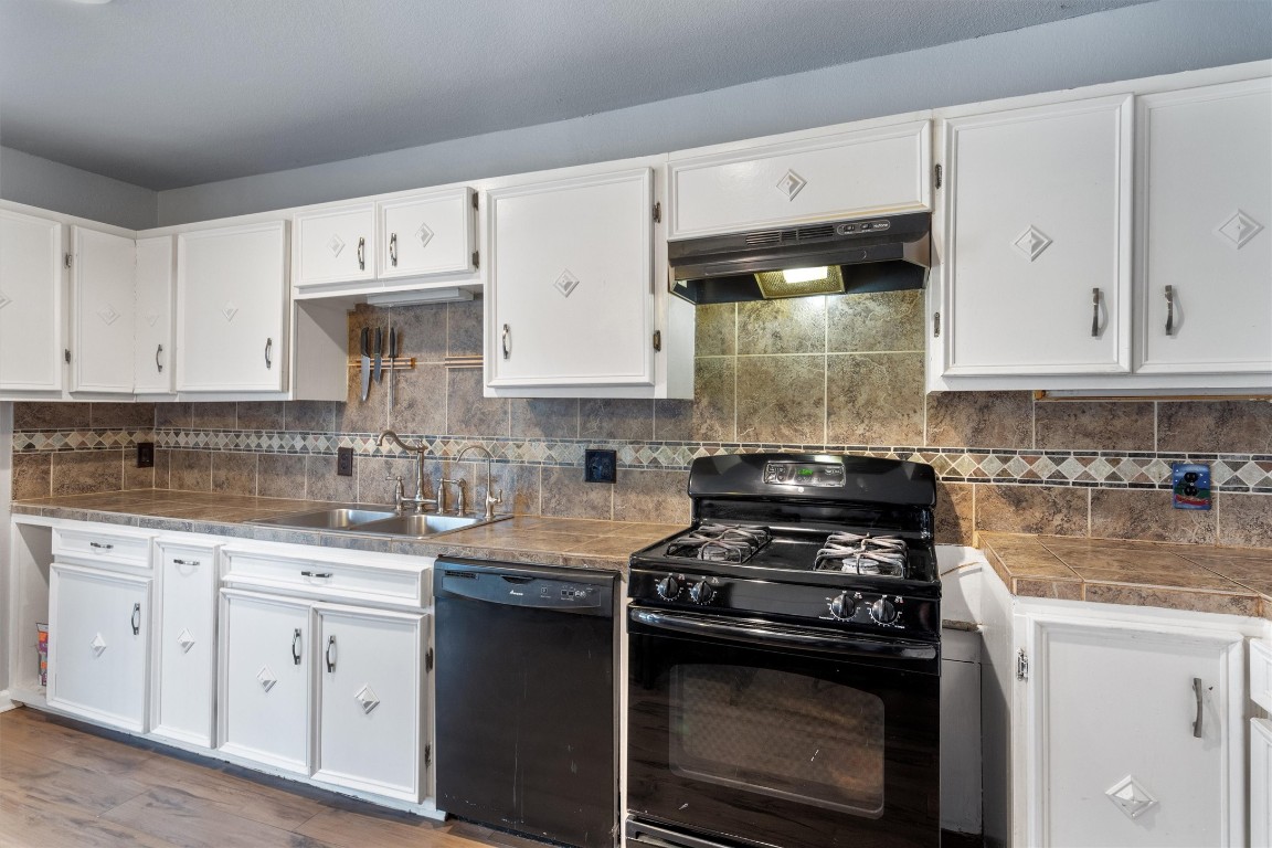 2203 Windy Hill Road Kyle, TX 78640 - Photo 16 of 29 a kitchen with white cabinets and appliances