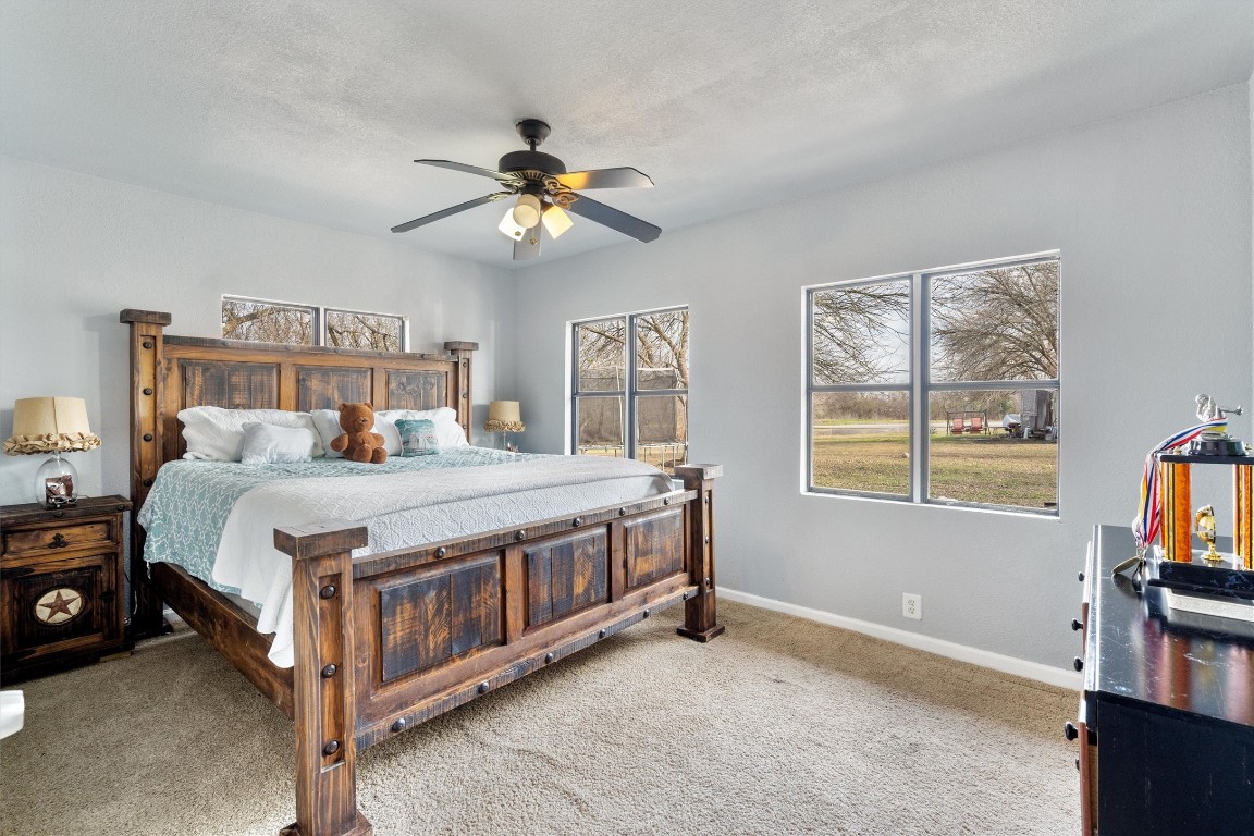 2203 Windy Hill Road Kyle, TX 78640 - Photo 23 of 29 a bed room with a bed and a window