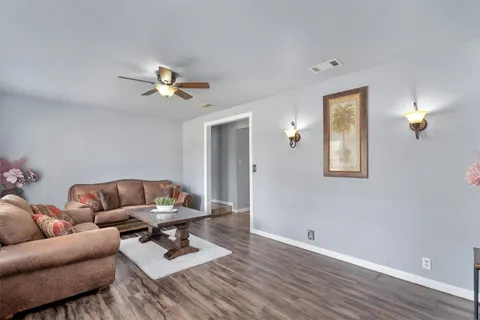 a living room with furniture a rug and a window