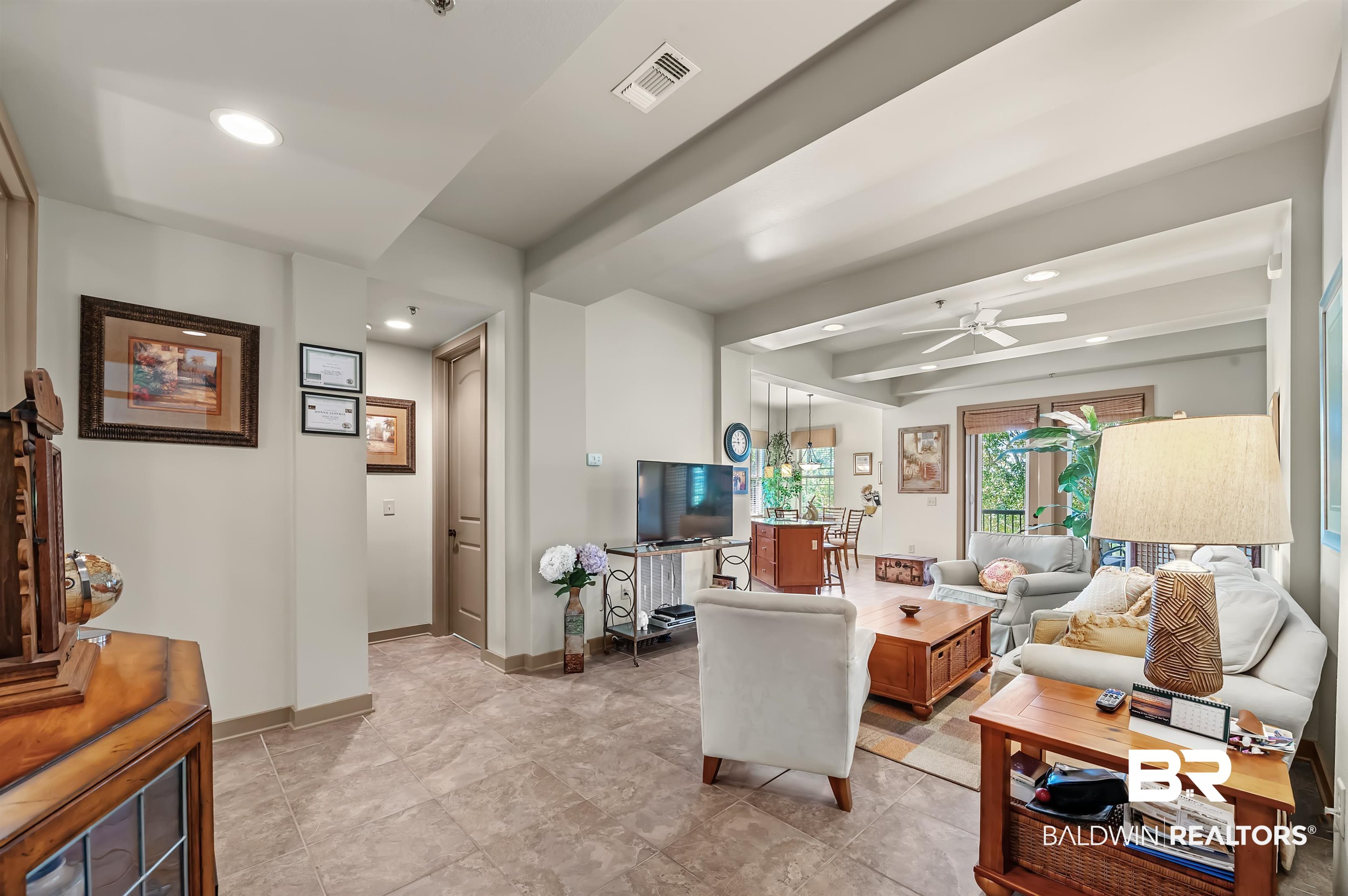 1430 Regency Road, Unit A301 Gulf Shores, AL 36542 - Photo 4 of 47 Living room with beamed ceiling and ceiling fan