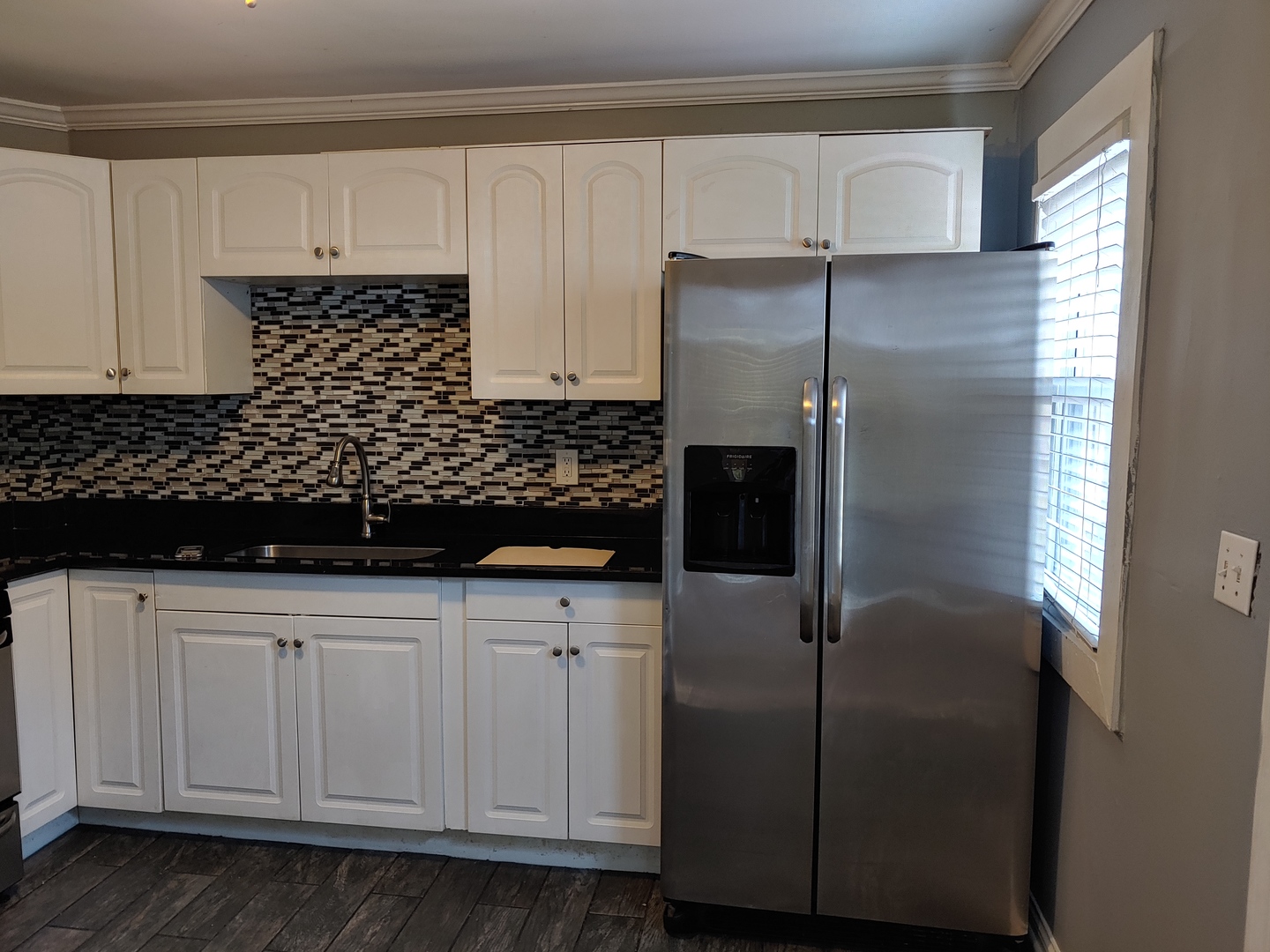 519 Prospect Place Joliet, IL 60436 - Photo 12 of 15 a kitchen with a refrigerator and cabinets