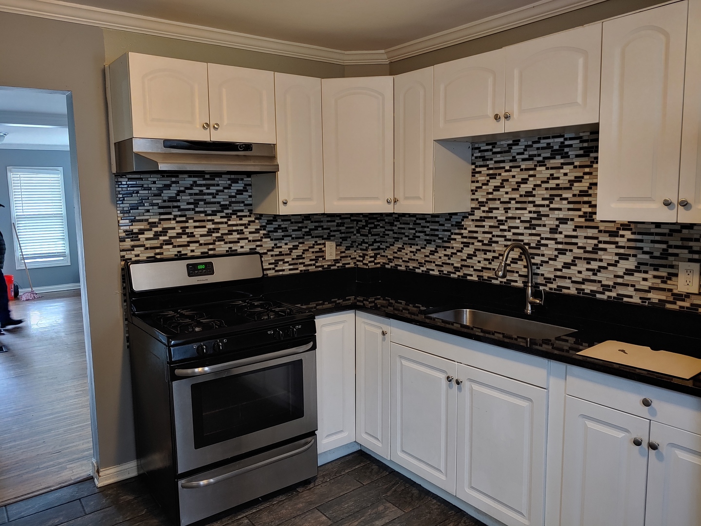 519 Prospect Place Joliet, IL 60436 - Photo 13 of 15 a kitchen with white cabinets and appliances