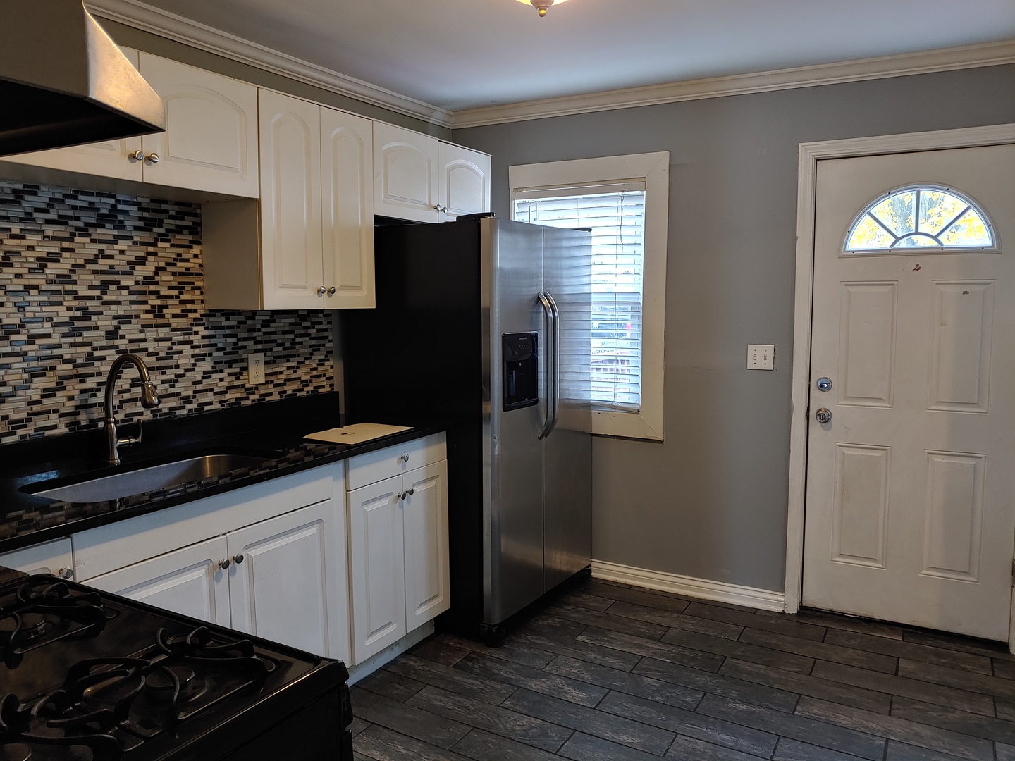 519 Prospect Place Joliet, IL 60436 - Photo 14 of 15 a kitchen with a sink and refrigerator