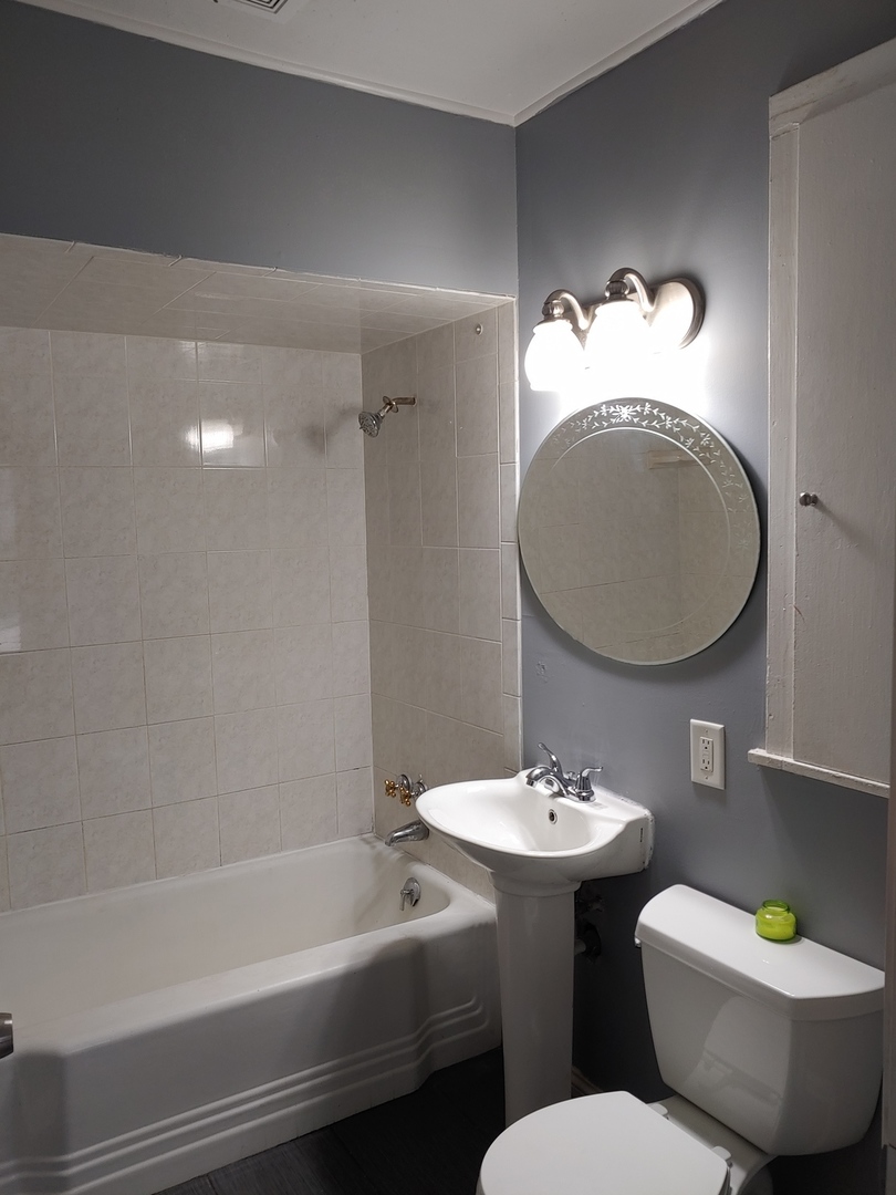 519 Prospect Place Joliet, IL 60436 - Photo 15 of 15 a bathroom with a sink a toilet and a mirror
