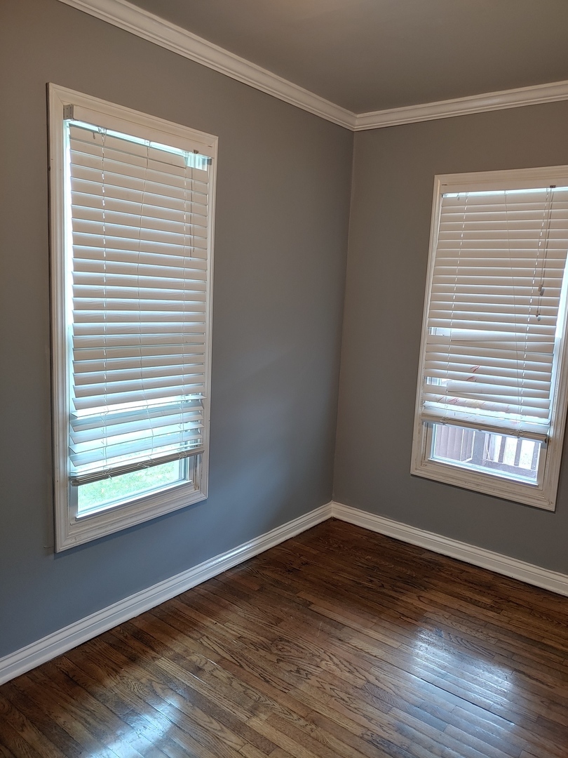 519 Prospect Place Joliet, IL 60436 - Photo 9 of 15 a view of an empty room with wooden floor and a window