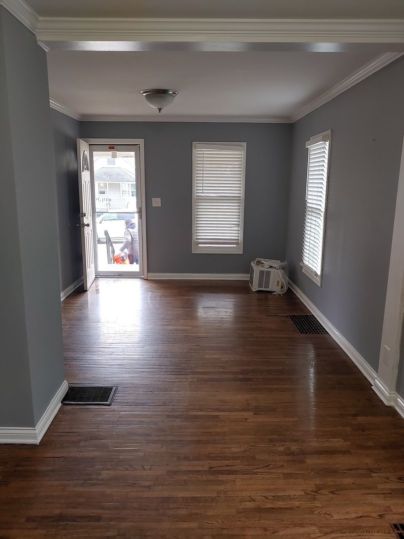 519 Prospect Place Joliet, IL 60436 - Photo 10 of 15 a view of an empty room with wooden floor and a window