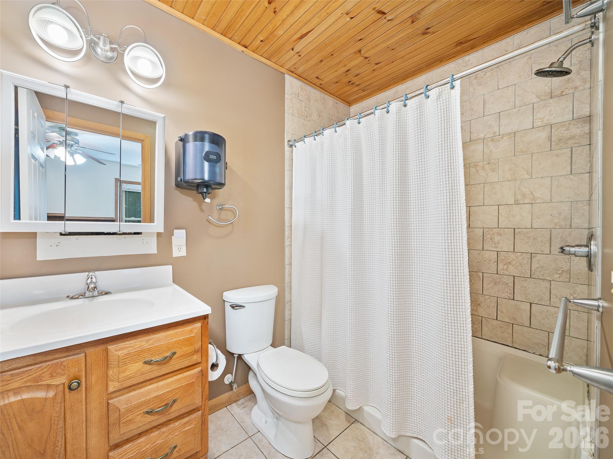 142 Wildflower Road Spruce Pine, NC 28777 - Photo 16 of 46 a bathroom with a granite countertop sink toilet and shower