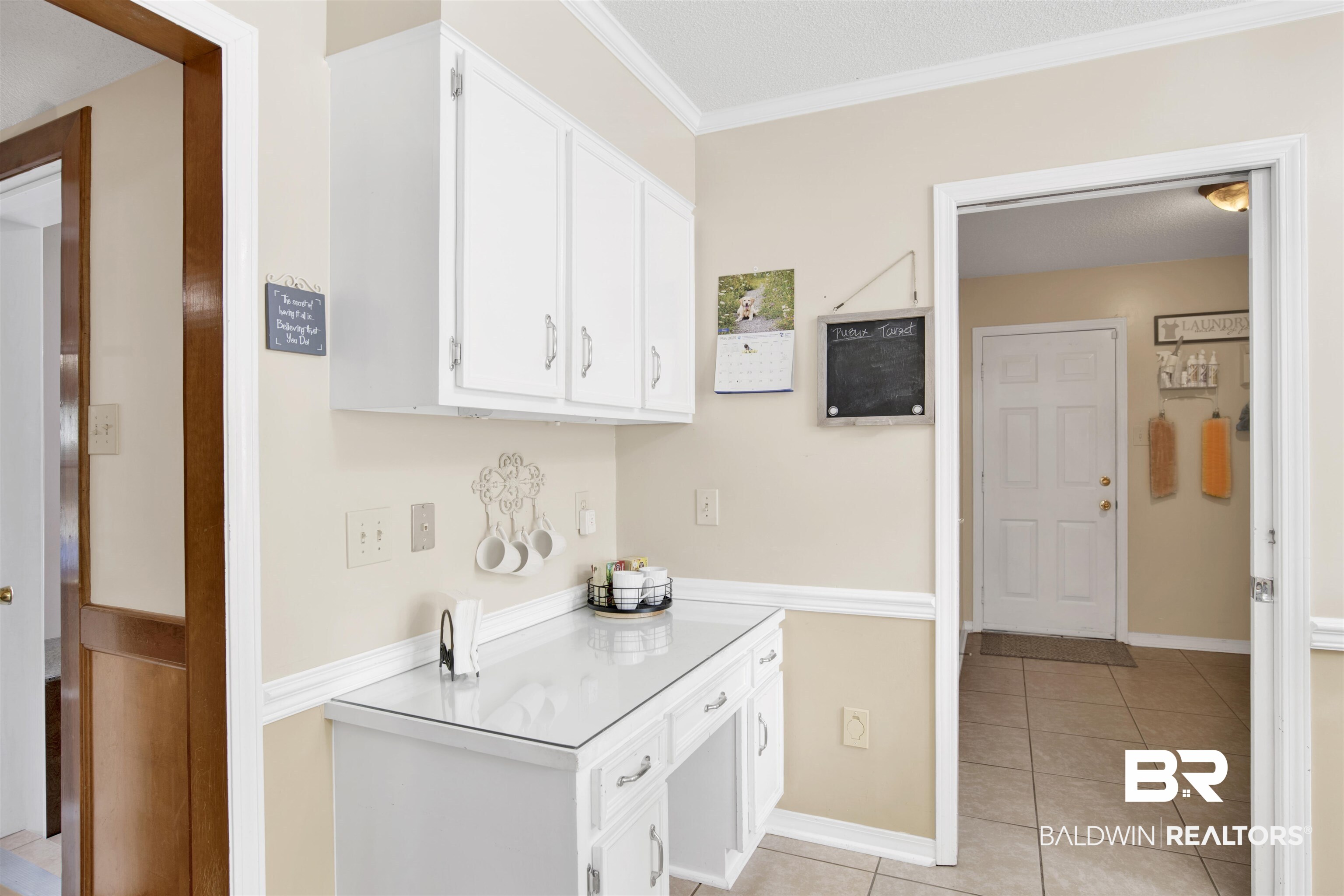 7431 Summer Court Mobile, AL 36695 - Photo 15 of 37 Kitchen featuring light tile patterned floors, white cabinets, crown molding, light countertops, and baseboards