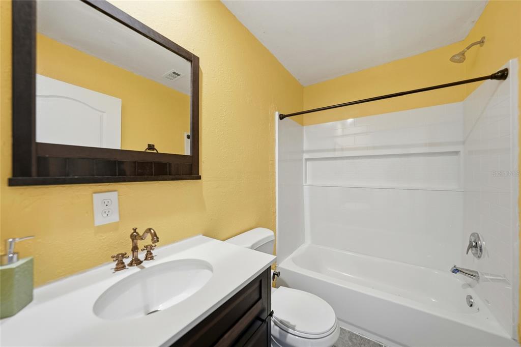 11337 Pineapple Road Punta Gorda, FL 33955 - Photo 17 of 25 a bathroom with a bathtub shower sink vanity and toilet