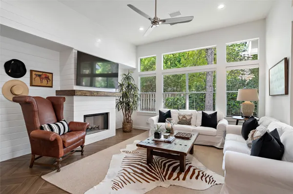 a living room with furniture a fireplace and a flat screen tv
