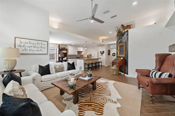 a living room with furniture kitchen view and a table