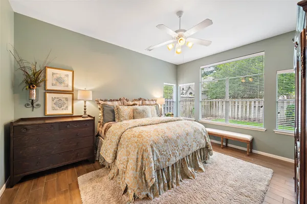 a spacious bedroom with a bed and a chandelier