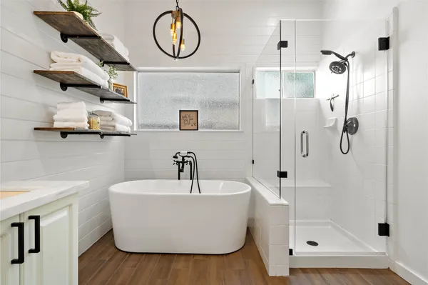 a bathroom with a sink a mirror and shower