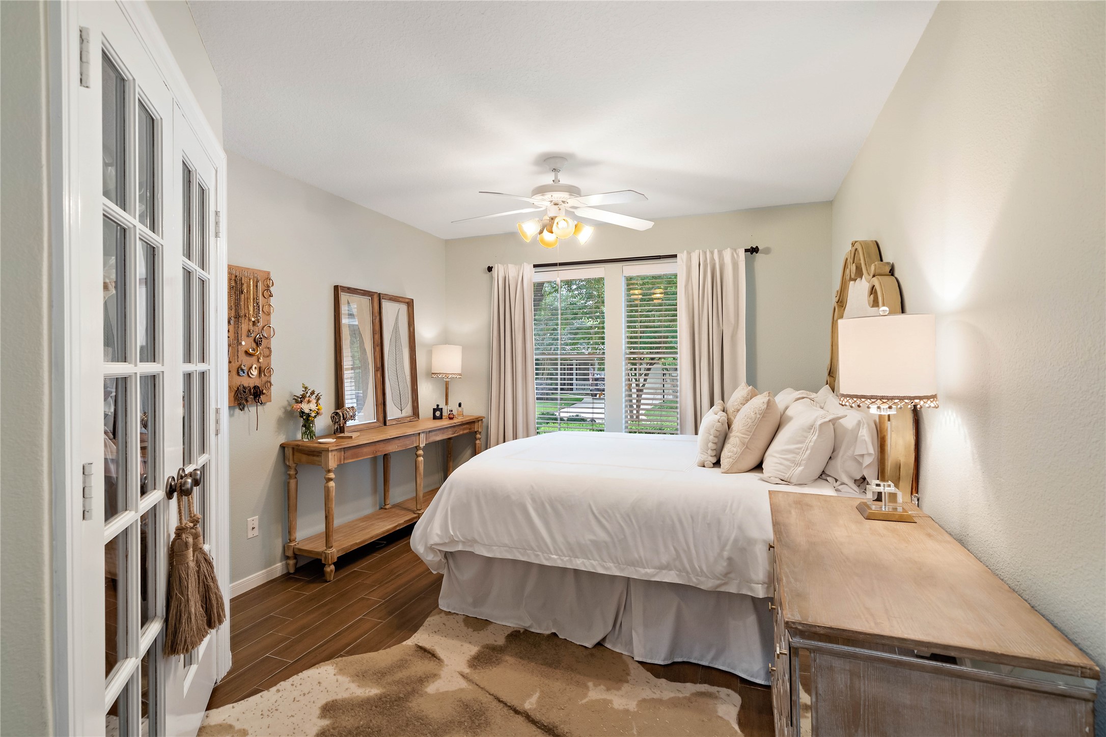 10 Vinca Trail Spring, TX 77382 - Photo 18 of 22 a bedroom with a large bed and a chandelier