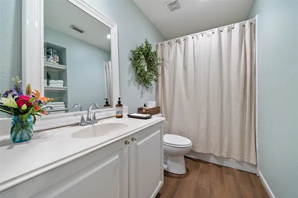 a bathroom with a sink a toilet and a mirror