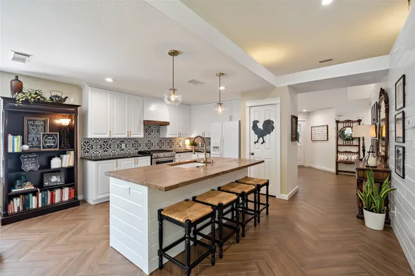 a large kitchen with lots of counter space and stainless steel appliances