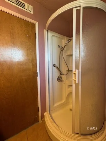 a view of porch with a table and chairs under an umbrella