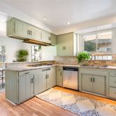 a kitchen with stainless steel appliances granite countertop a sink and cabinets
