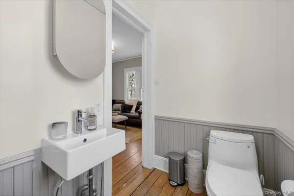 a bathroom with a toilet a sink and mirror