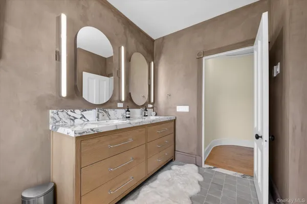 a bathroom with a granite countertop sink and a mirror
